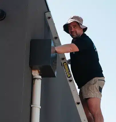 Plumber conducting rooftop plumbing inspection