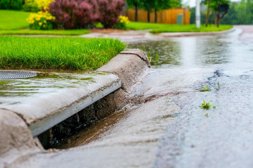 Stormwater flowing into street stormwater drain after a rainstorm