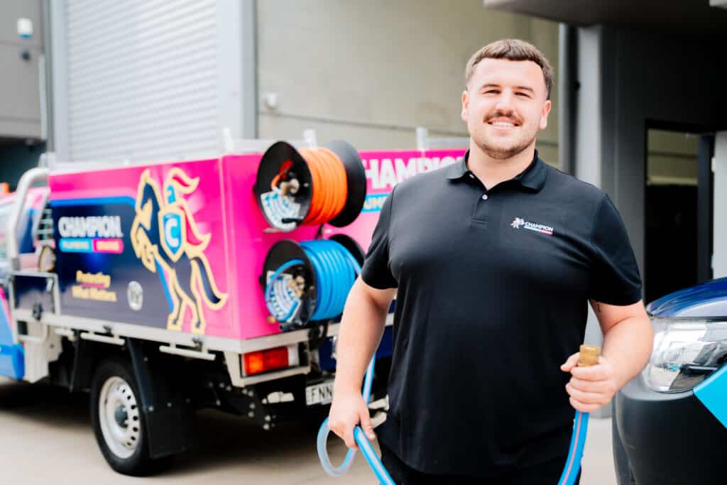Plumber standing and smiling at residential job