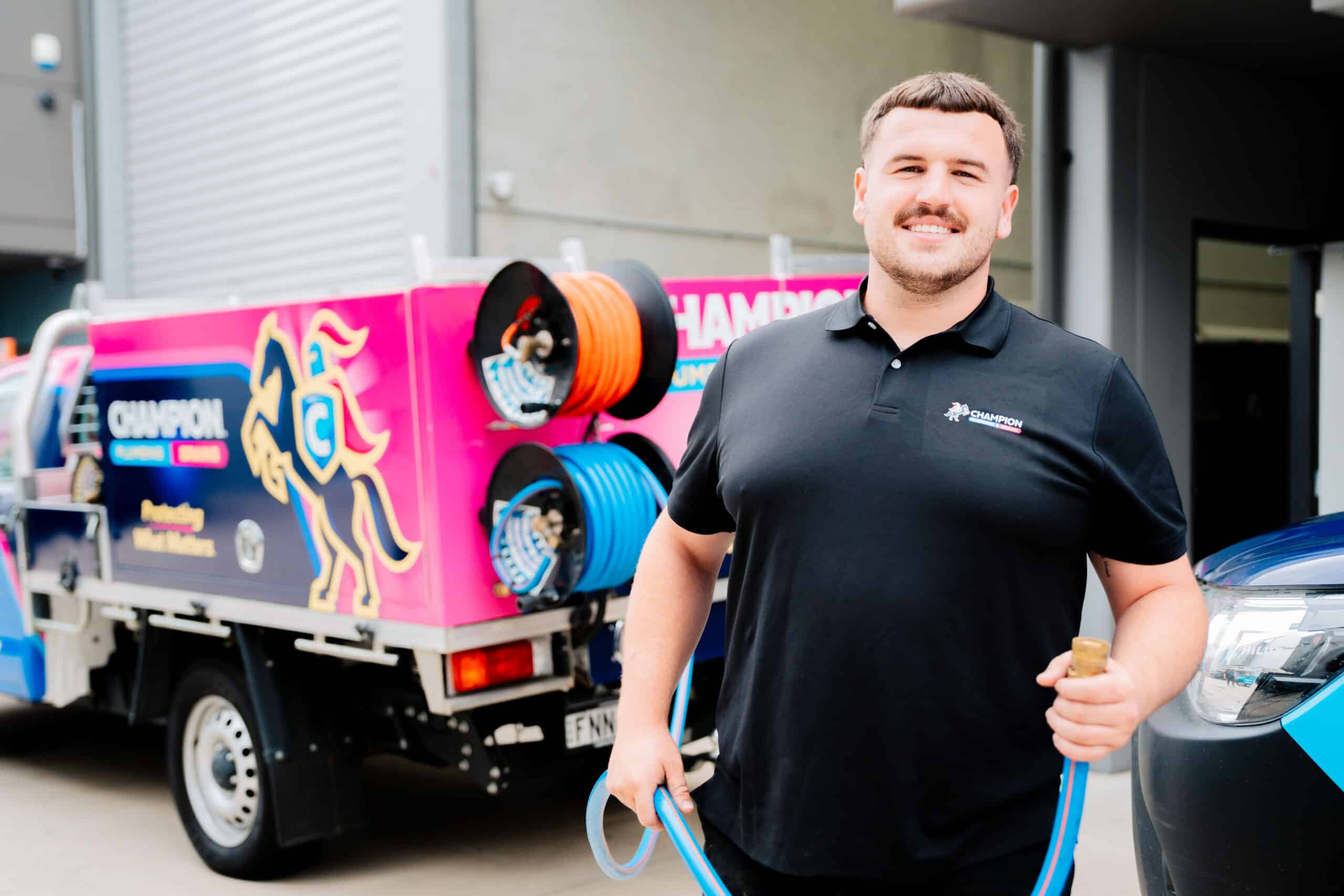 Plumber standing and smiling at residential job