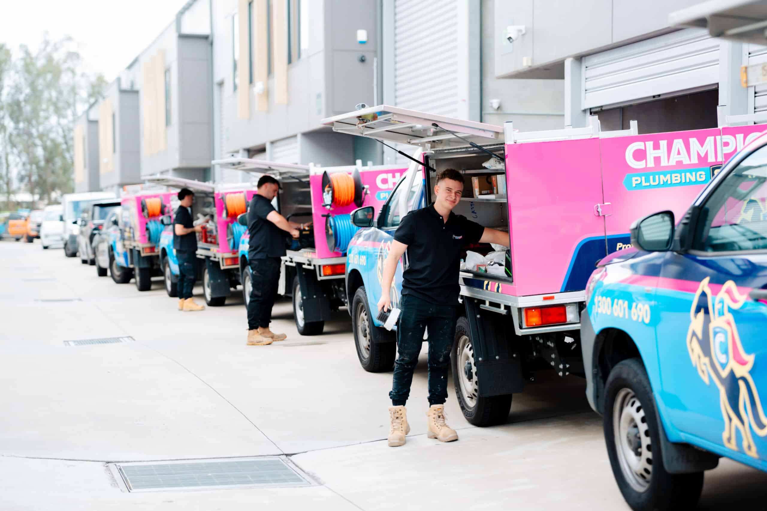Service van with plumbing team on suburban street