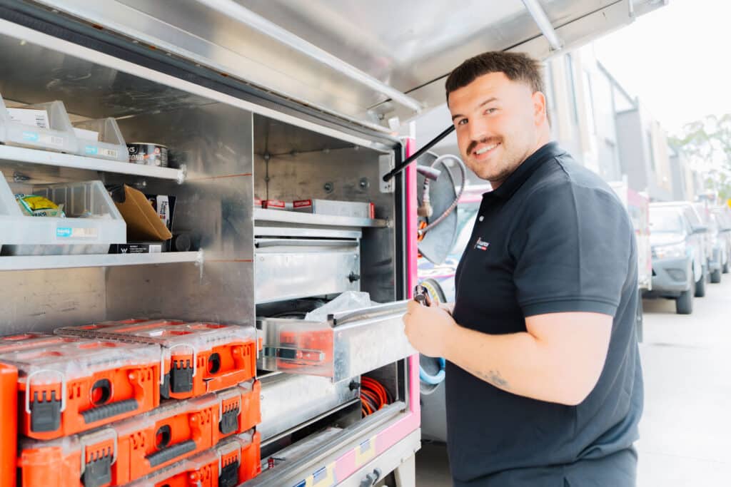 Plumber using power tools on plumbing job