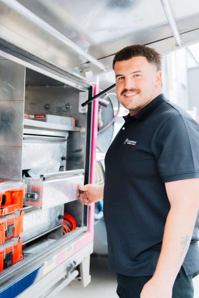 Plumber working on vertical pipe installation