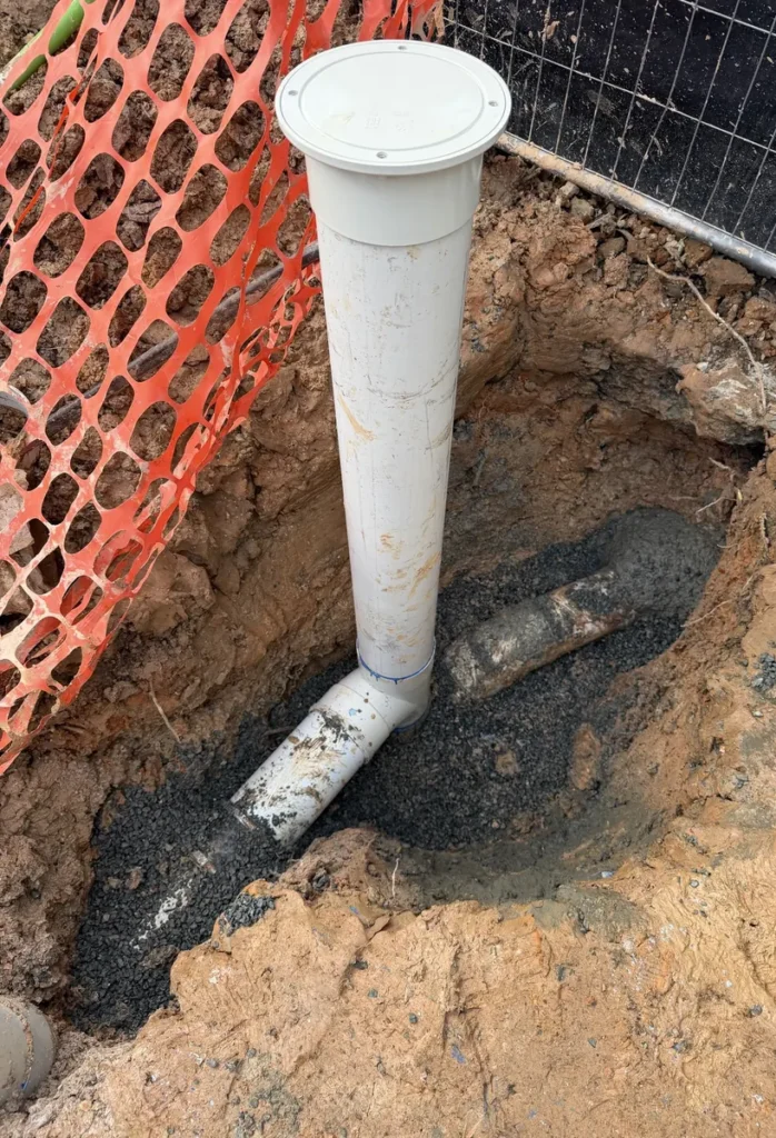 New PVC sewer pipe and inspection riser replacing collapsed clay sewer pipework in Lilyfield