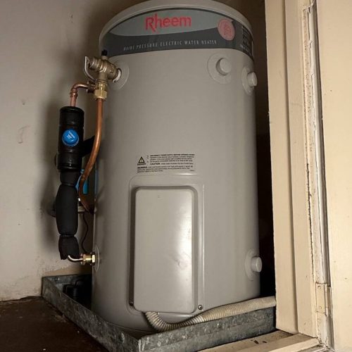New Rheem electric hot water system installed in a cupboard in Potts Point after the old unit burst